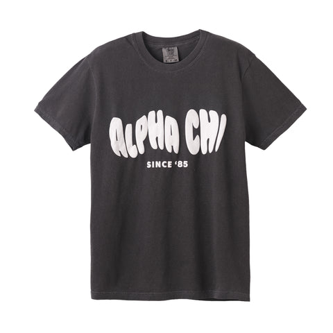 Black t-shirt with 'Alpha Chi Since '85' text on a white background